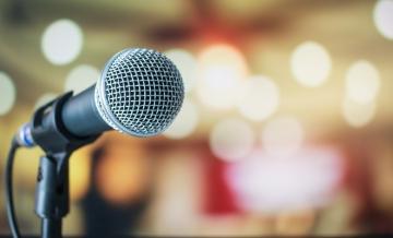 Microphone on stand with lights in the background